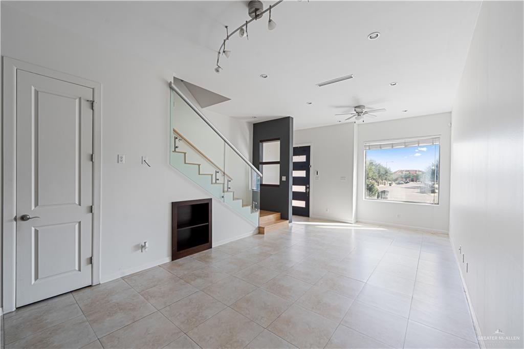 1209 Olympia Avenue, Unit 3 McAllen, TX 78503 - Photo 9 of 21 an empty room with furniture and a fireplace
