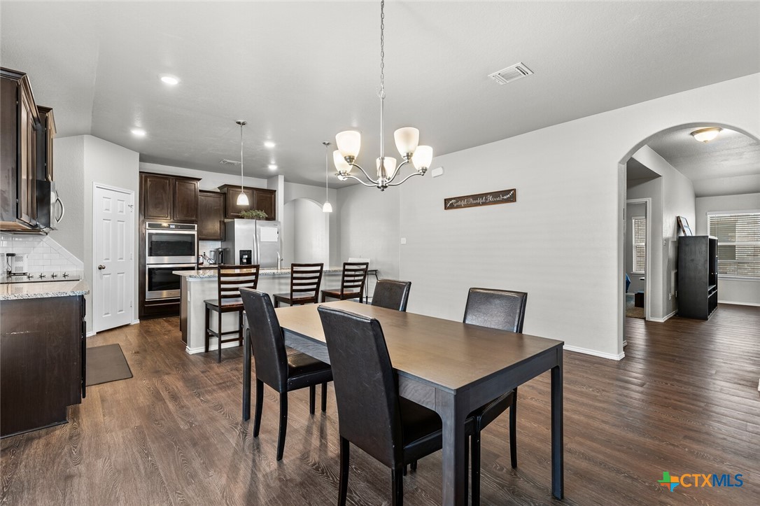 271 Bainbridge Road Temple, TX 76502 - Photo 11 of 36 a view of a dining room with furniture and wooden floor