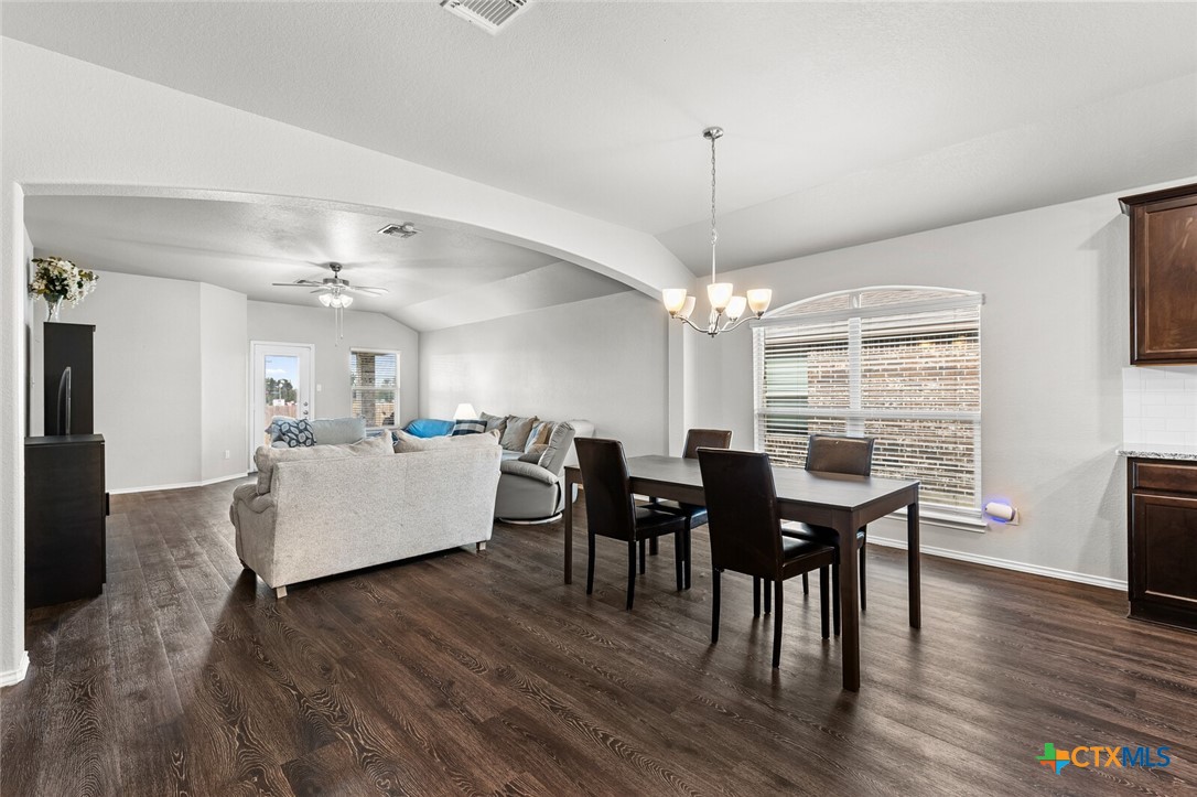 271 Bainbridge Road Temple, TX 76502 - Photo 12 of 36 a living room with furniture dining table wooden floor and a chandelier