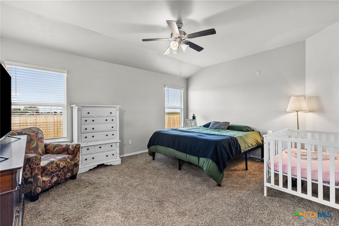 271 Bainbridge Road Temple, TX 76502 - Photo 17 of 36 a bedroom with a bed and a chandelier