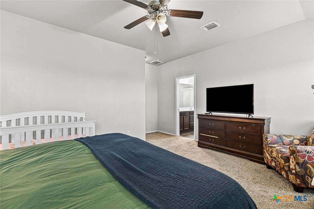 271 Bainbridge Road Temple, TX 76502 - Photo 18 of 36 a bedroom with a bed and a flat screen tv