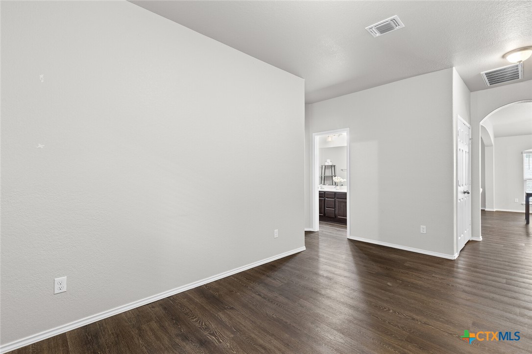 271 Bainbridge Road Temple, TX 76502 - Photo 23 of 36 a view of an empty room with wooden floor and a window