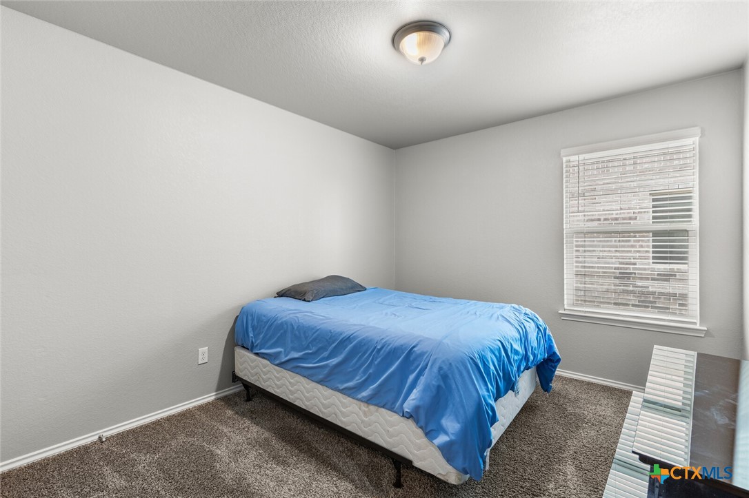 271 Bainbridge Road Temple, TX 76502 - Photo 24 of 36 a bed sitting in a room next to a window