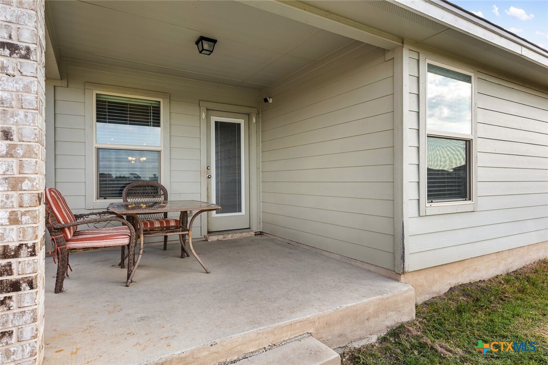 271 Bainbridge Road Temple, TX 76502 - Photo 32 of 36 a balcony with table and chairs and a barbeque