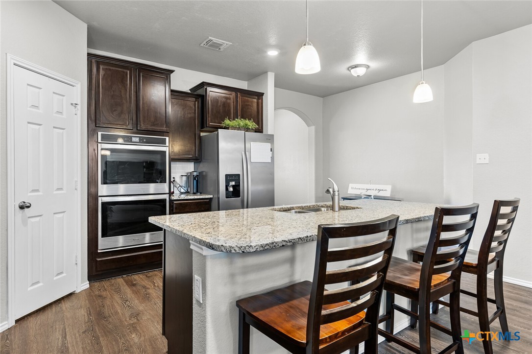 271 Bainbridge Road Temple, TX 76502 - Photo 7 of 36 a kitchen with a table and refrigerator