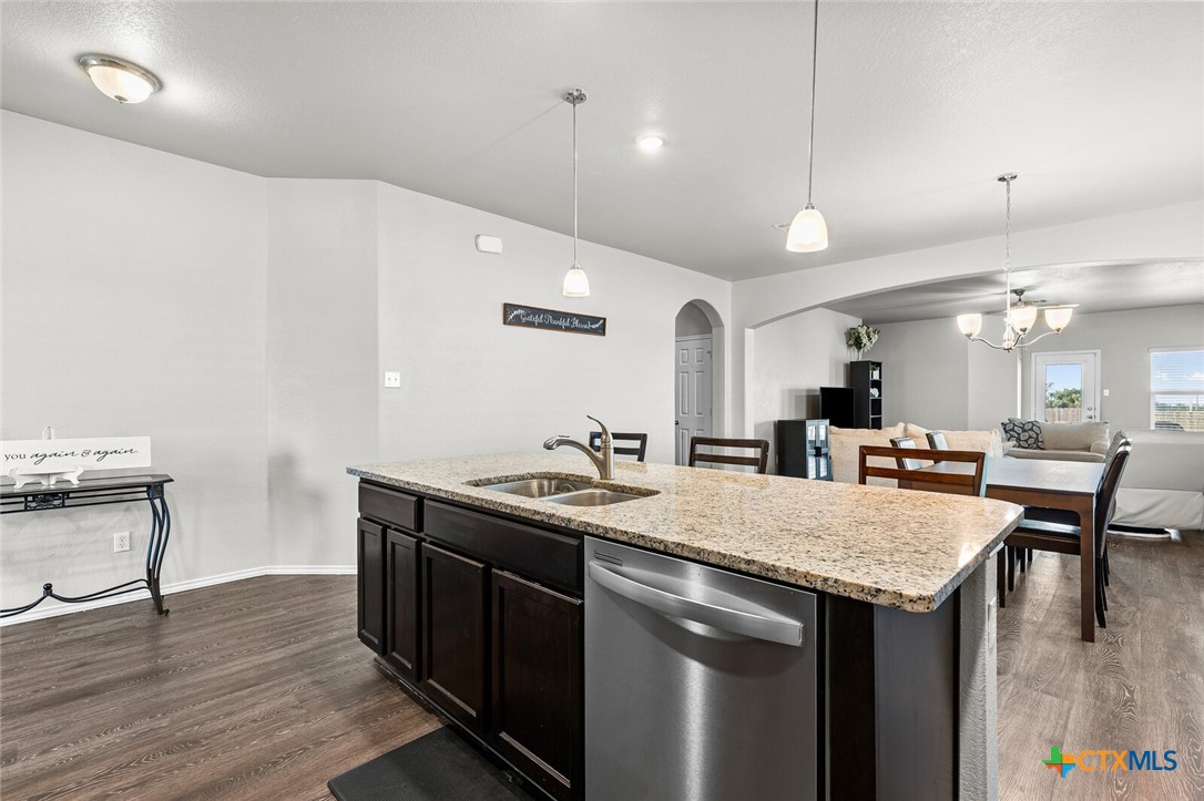 271 Bainbridge Road Temple, TX 76502 - Photo 8 of 36 a kitchen with a wooden floor and chairs