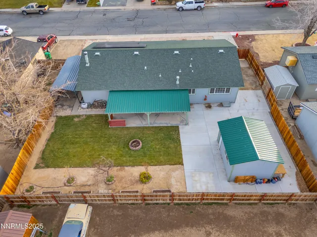 an aerial view of residential houses with outdoor space and parking