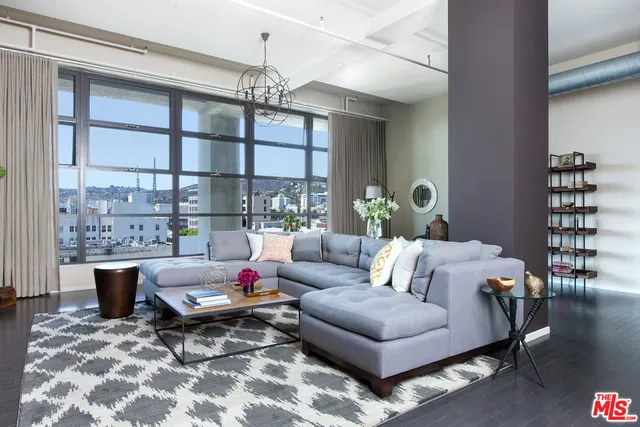 a living room with furniture and a chandelier