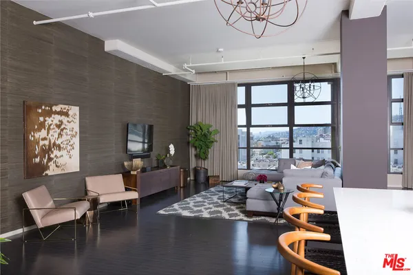 a view of a room with wooden floor pool table and windows