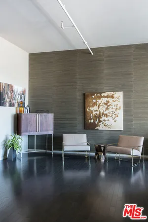 a living room with furniture wooden floor and a table