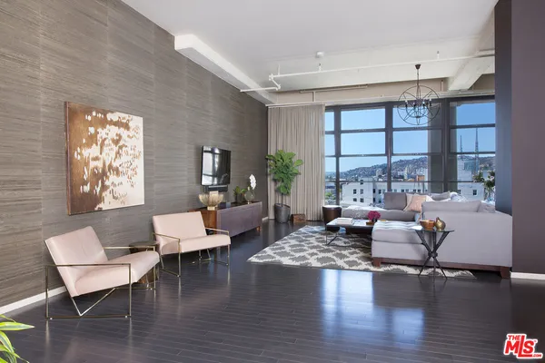 a living room with furniture and a chandelier