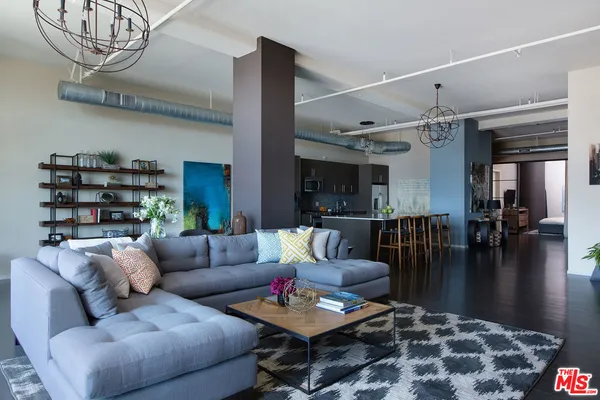 a living room with furniture and a chandelier