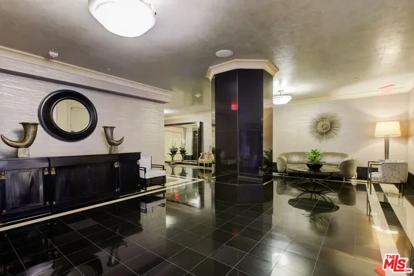 a living room with furniture and a mirror