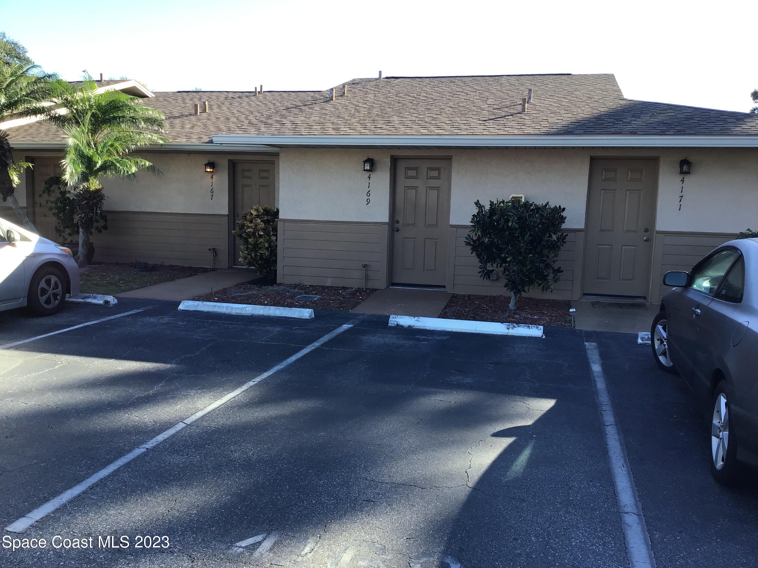 4169 Dividend Avenue Rockledge, FL 32955 - Photo 1 of 12 a front view of a house with a yard