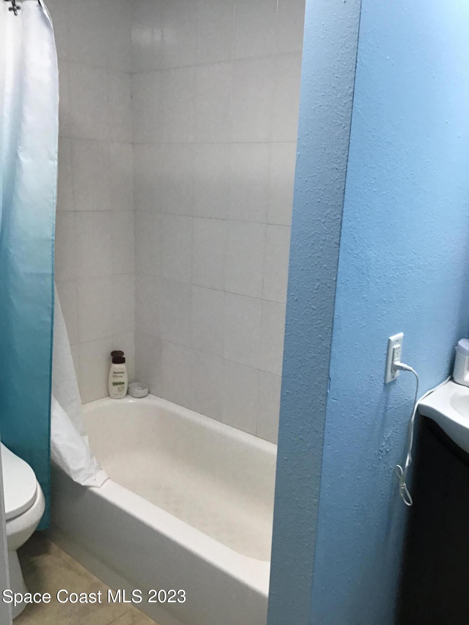 4169 Dividend Avenue Rockledge, FL 32955 - Photo 12 of 12 a bathroom with a bathtub and toilet