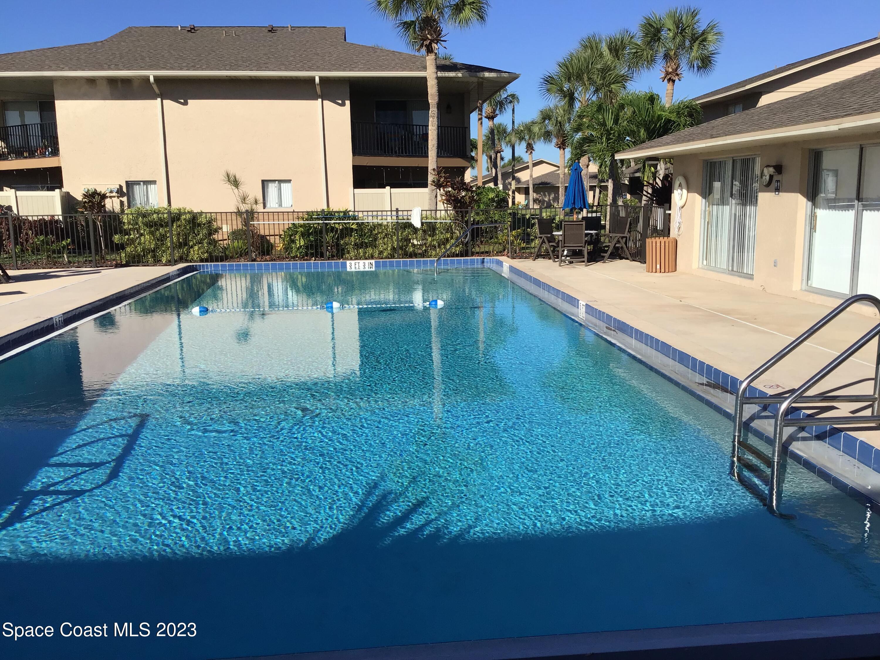4169 Dividend Avenue Rockledge, FL 32955 - Photo 3 of 12 a swimming pool with outdoor seating
