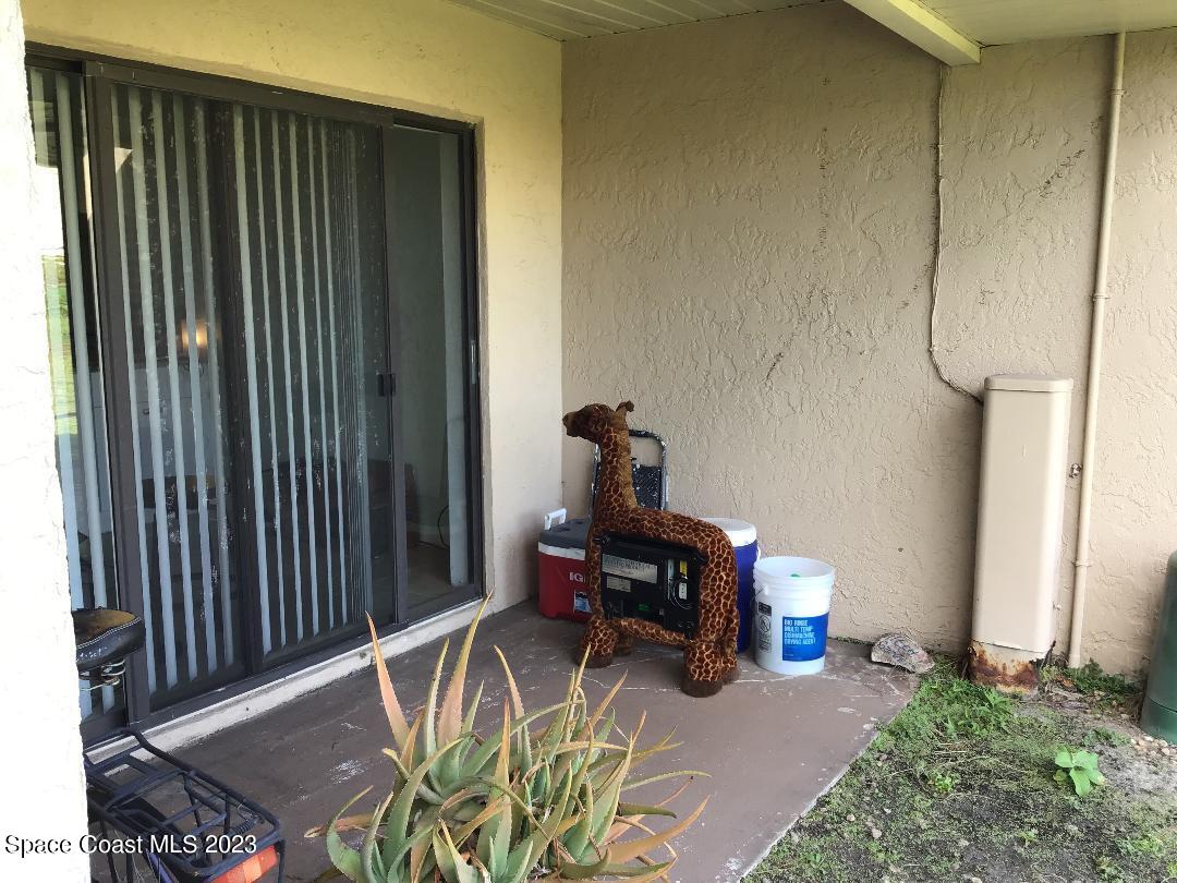 4169 Dividend Avenue Rockledge, FL 32955 - Photo 9 of 12 a view of a patio with table and chairs