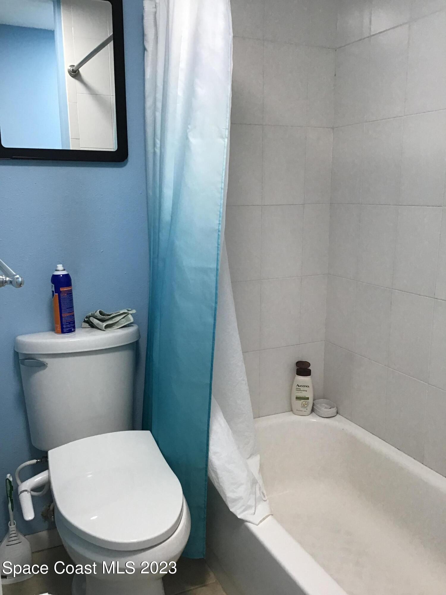 4169 Dividend Avenue Rockledge, FL 32955 - Photo 10 of 12 a white toilet sitting next to a bath tub