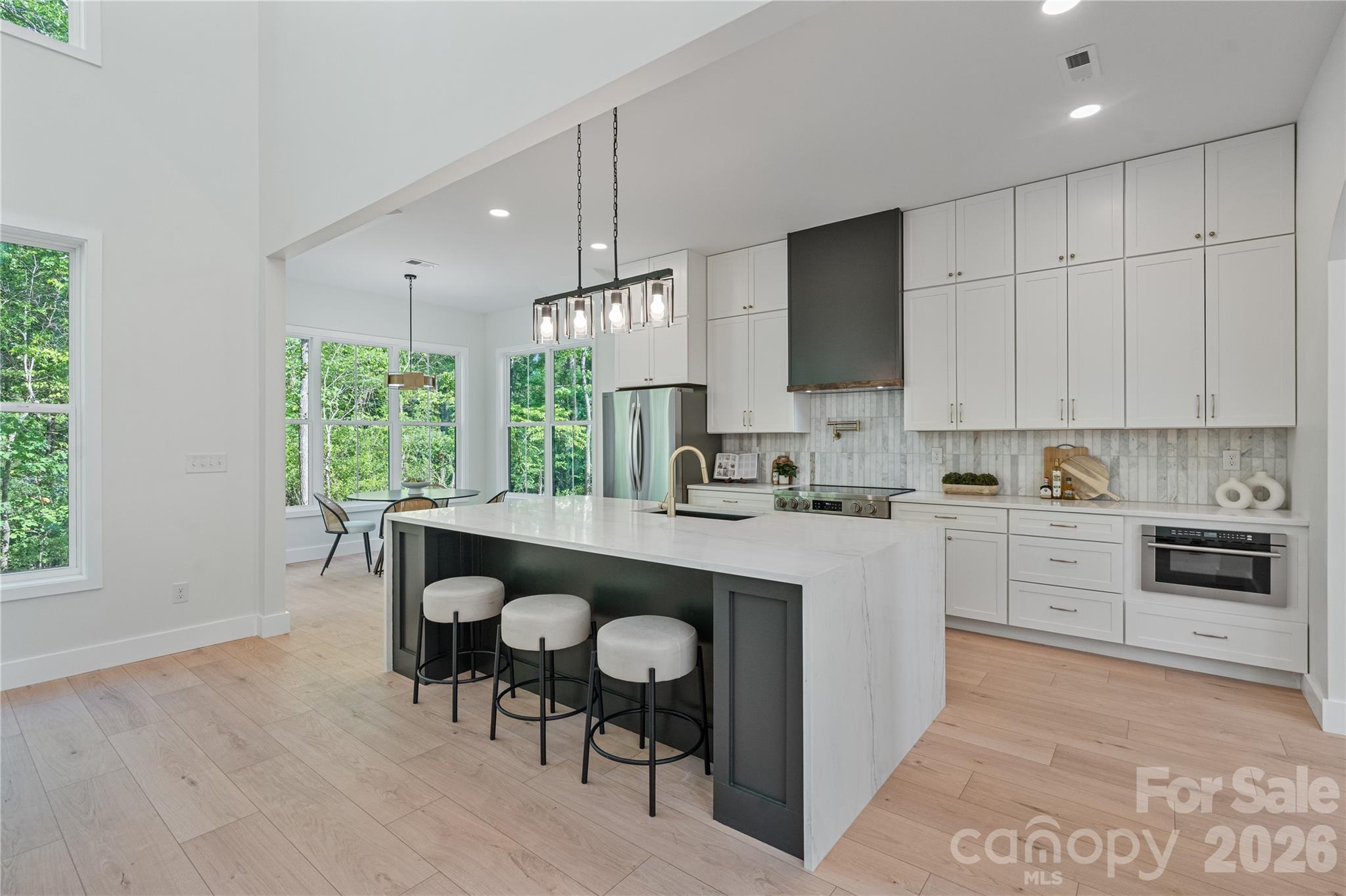 460 Riddle Mill Road Clover, SC 29710 - Photo 3 of 48 a kitchen with kitchen island granite countertop a sink cabinets and dining table