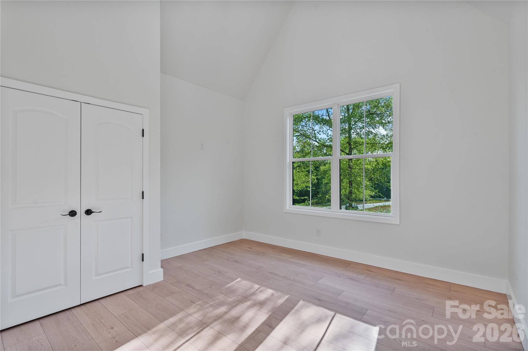 460 Riddle Mill Road Clover, SC 29710 - Photo 33 of 48 an empty room with wooden floor and windows