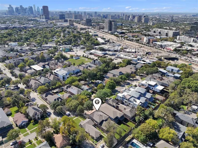 an aerial view of residential houses with city view