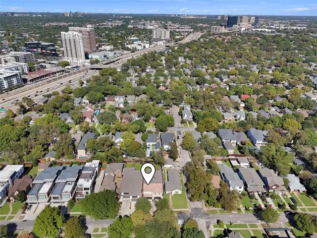an aerial view of residential building with parking and yard