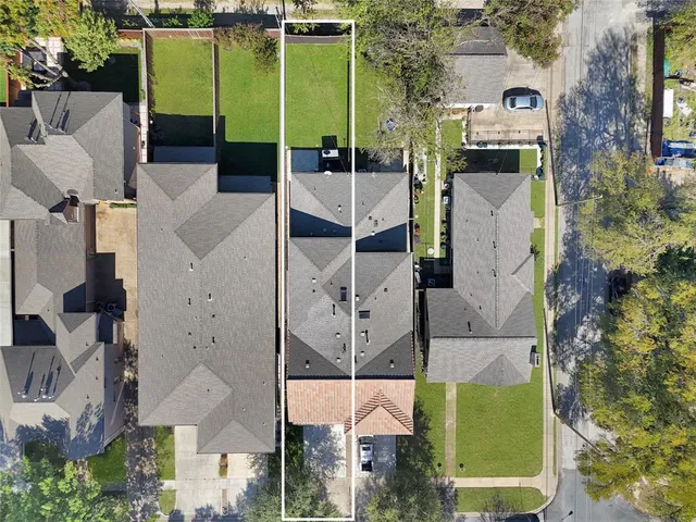 an aerial view of a house with a yard