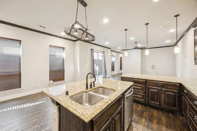 a kitchen with stainless steel appliances granite countertop stove a sink and a refrigerator