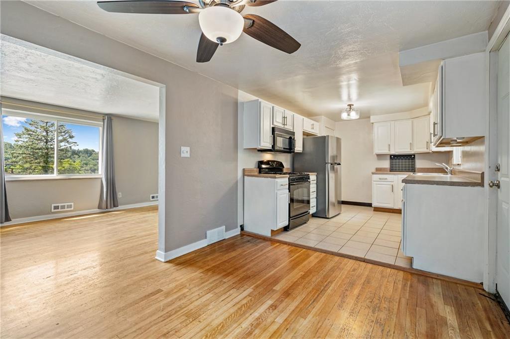 2106 Lappe Lane Pittsburgh, PA 15212 - Photo 4 of 20 a kitchen with stainless steel appliances granite countertop a refrigerator and a stove top oven