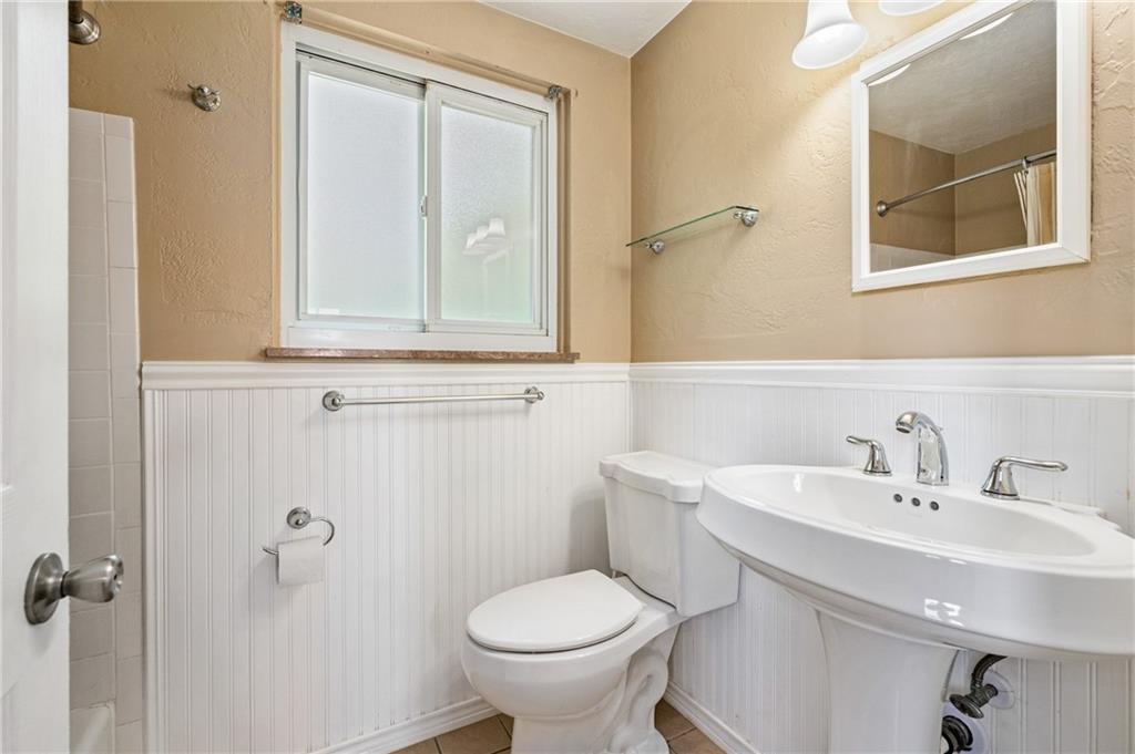 2106 Lappe Lane Pittsburgh, PA 15212 - Photo 9 of 20 a bathroom with a toilet sink and mirror