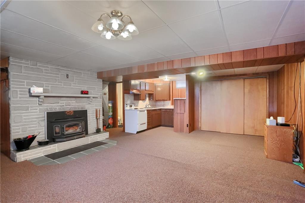 2749 Frew Mill Road New Castle, PA 16101 - Photo 11 of 18 a view of a livingroom with a fireplace a chandelier and windows