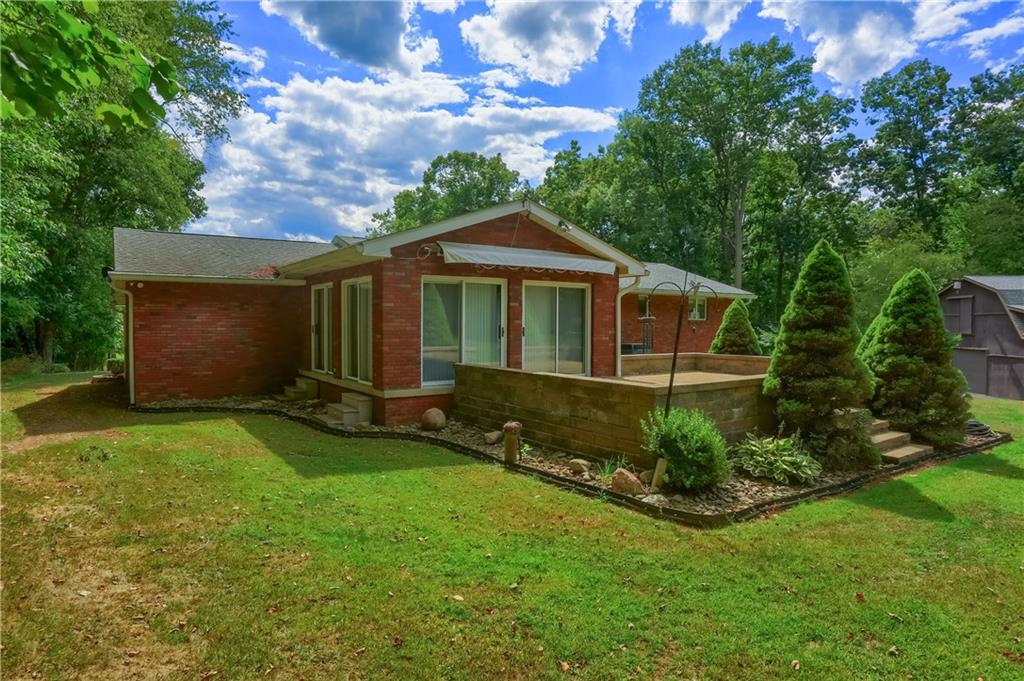 2749 Frew Mill Road New Castle, PA 16101 - Photo 13 of 18 a front view of a house with a garden