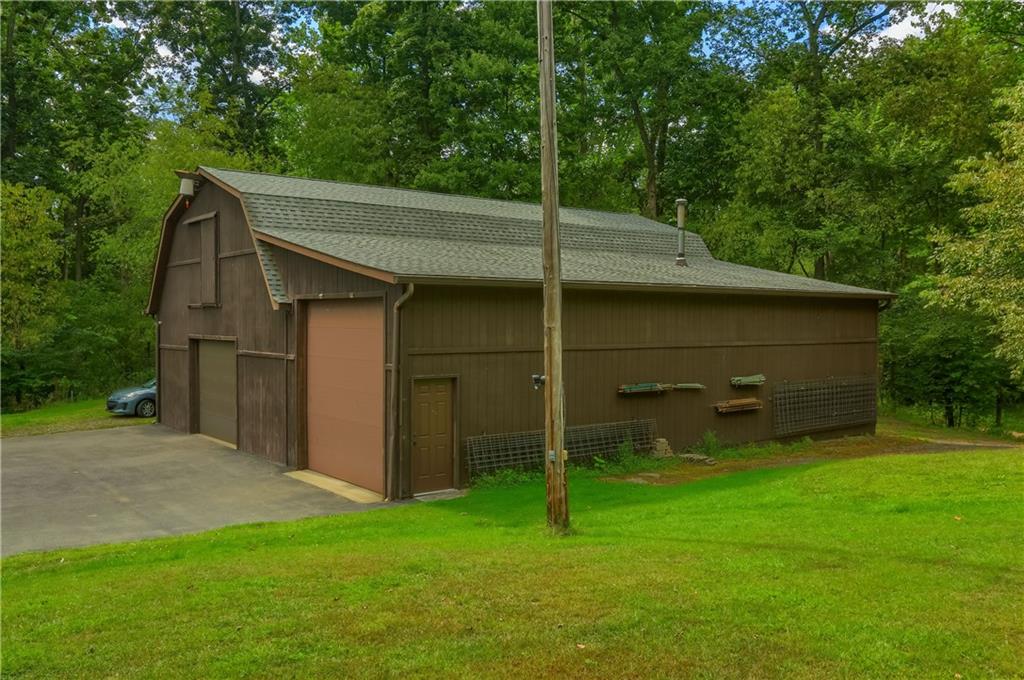 2749 Frew Mill Road New Castle, PA 16101 - Photo 5 of 18 a backyard of a house with plants and large tree