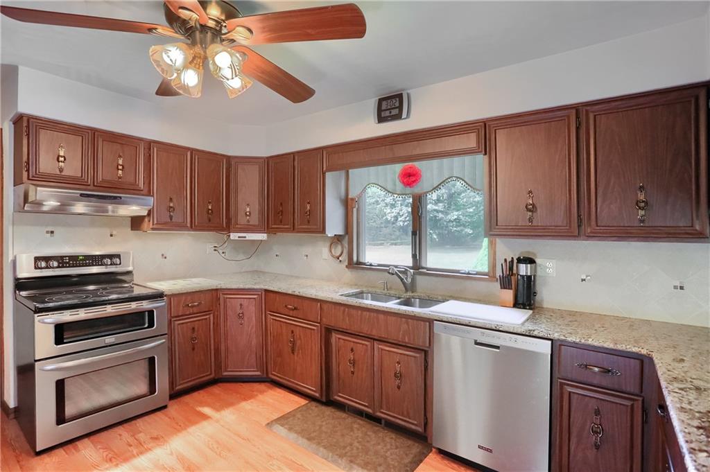 2749 Frew Mill Road New Castle, PA 16101 - Photo 8 of 18 a kitchen with kitchen island granite countertop a sink cabinets stainless steel appliances and a counter space