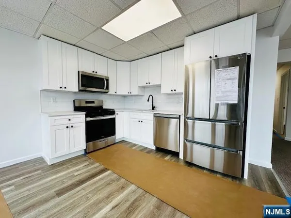 a kitchen with stainless steel appliances granite countertop a refrigerator stove a sink and dishwasher