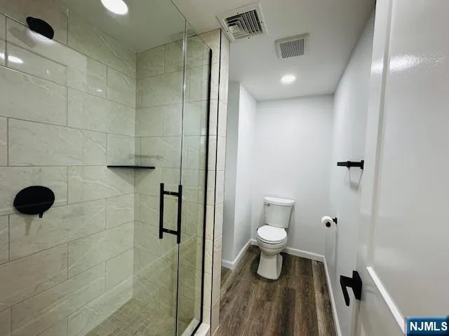 a bathroom with a toilet and a shower