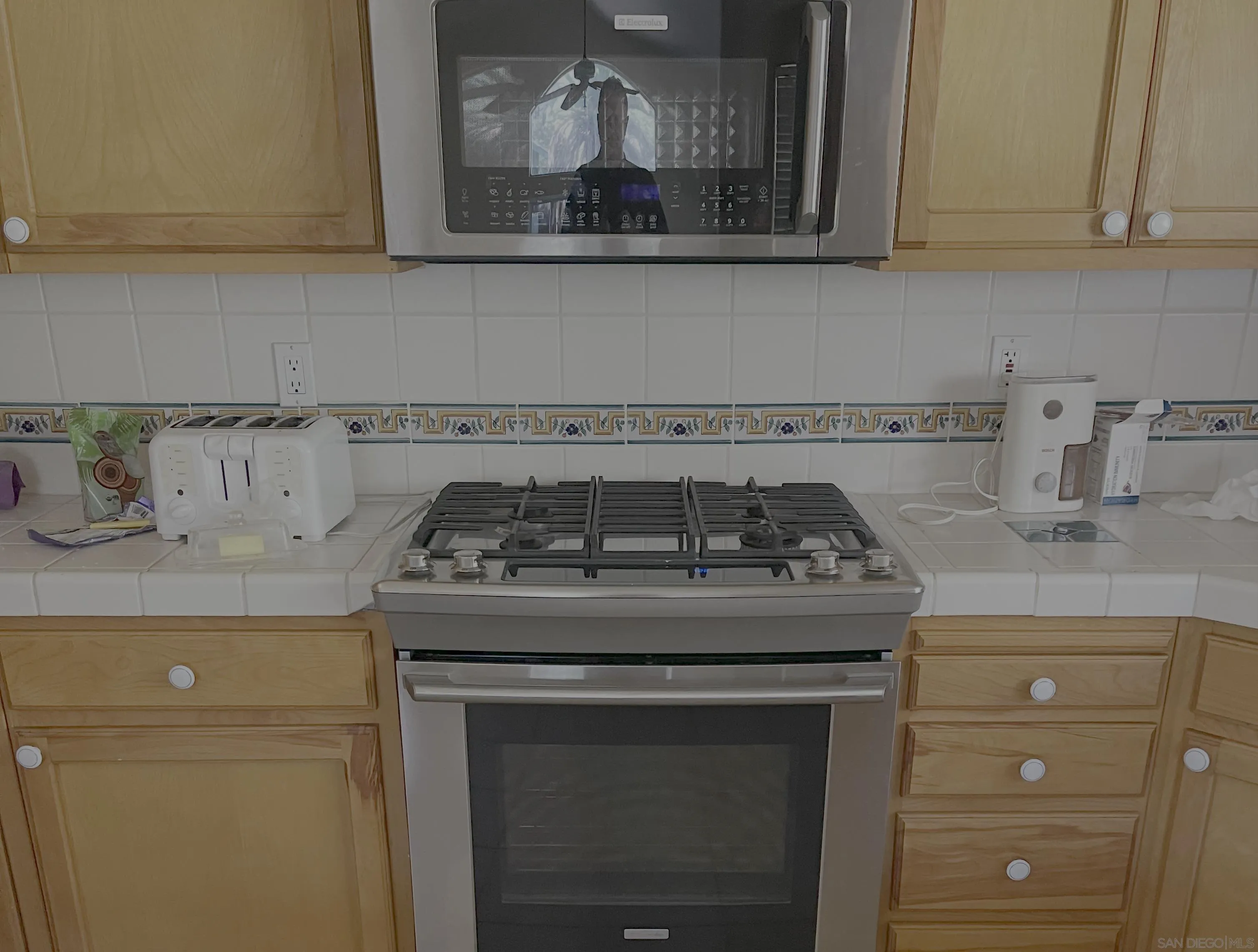 32906 Rincon Rancho Road Pauma Valley, CA 92061 - Photo 9 of 15 a stove top oven sitting inside of a kitchen