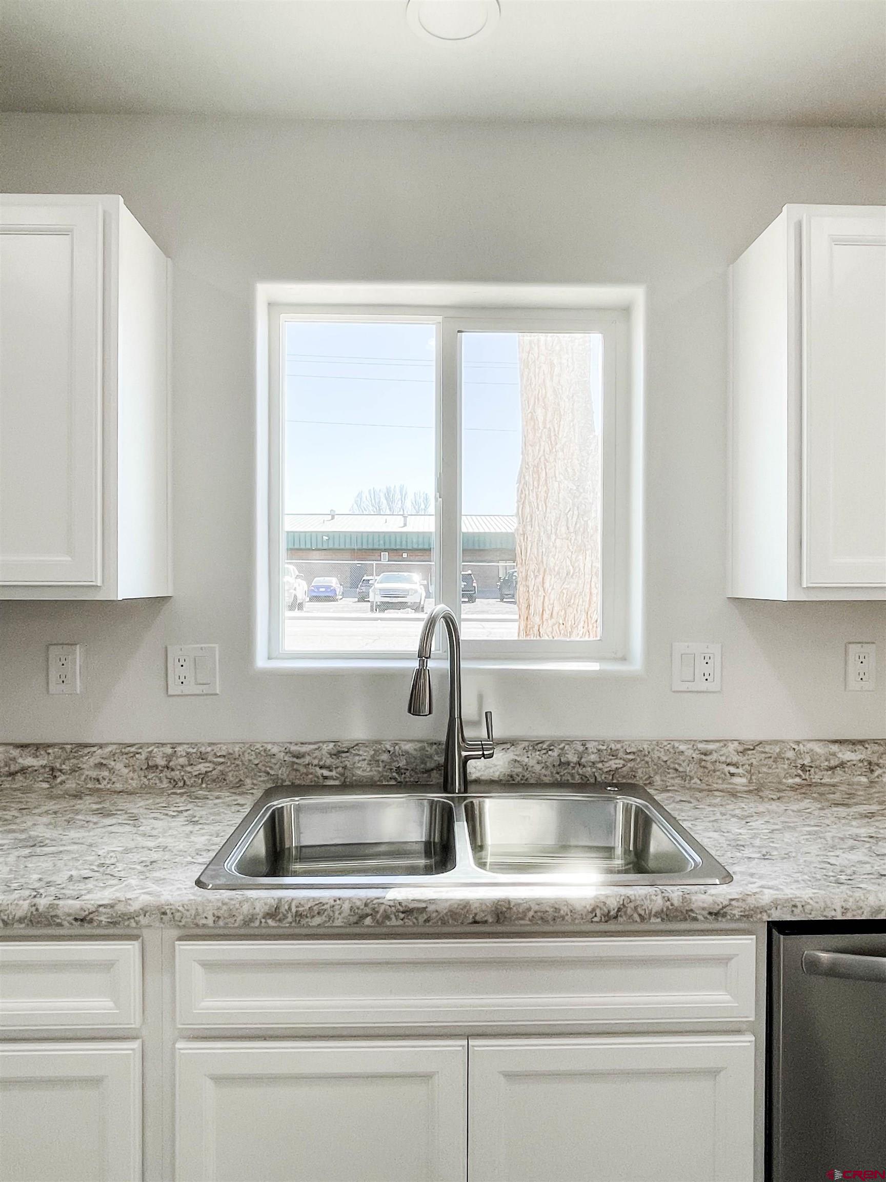 554 A Street Delta, CO 81416 - Photo 12 of 33 a kitchen with granite countertop a sink and a window