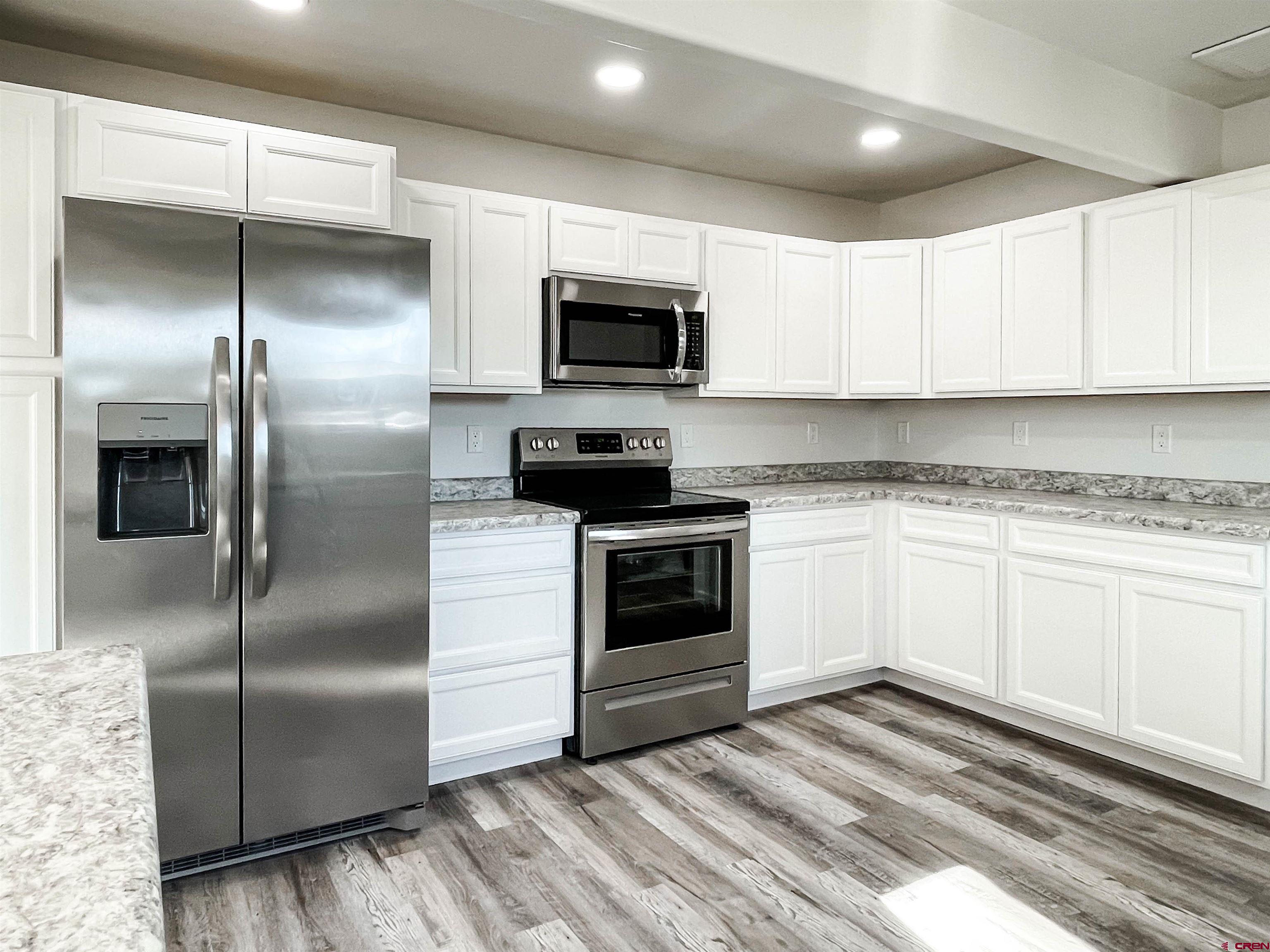 554 A Street Delta, CO 81416 - Photo 13 of 33 a kitchen with a refrigerator stove and microwave