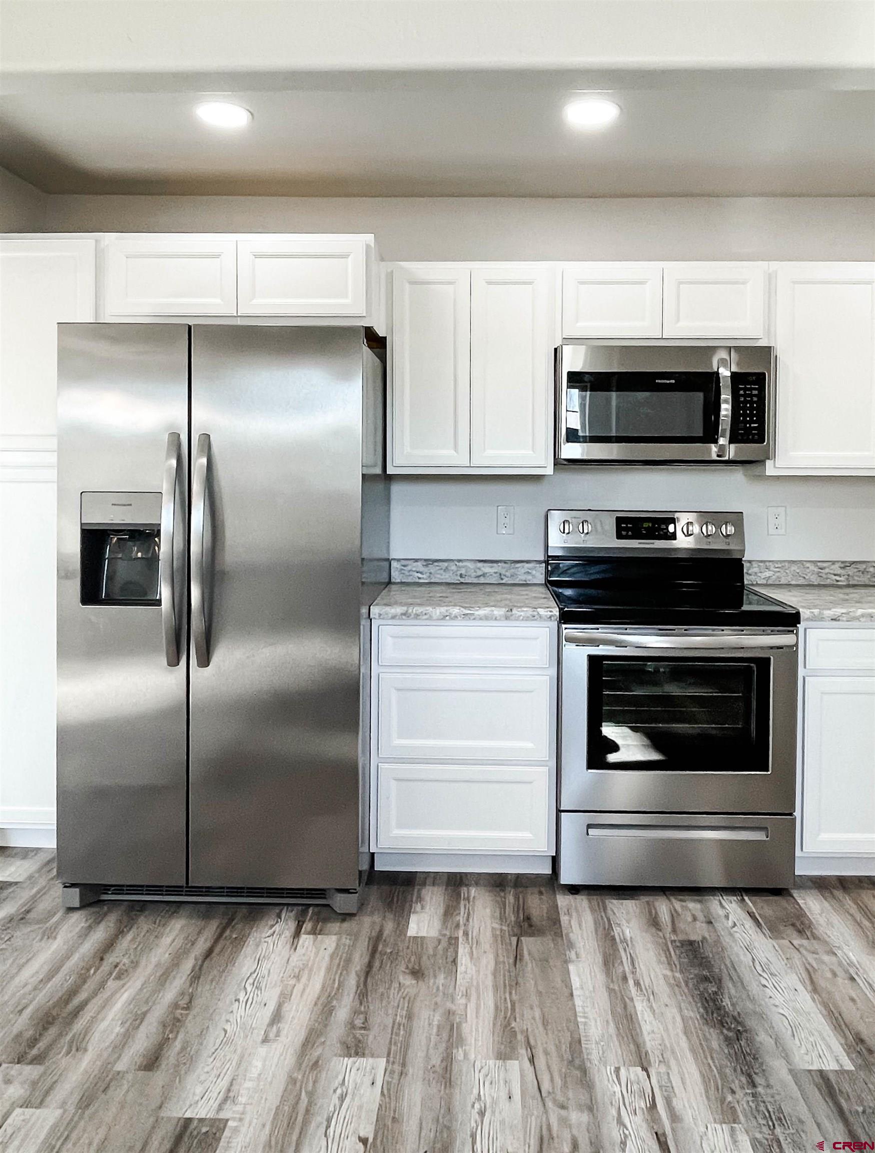 554 A Street Delta, CO 81416 - Photo 14 of 33 a kitchen with granite countertop a stainless steel appliances and cabinets
