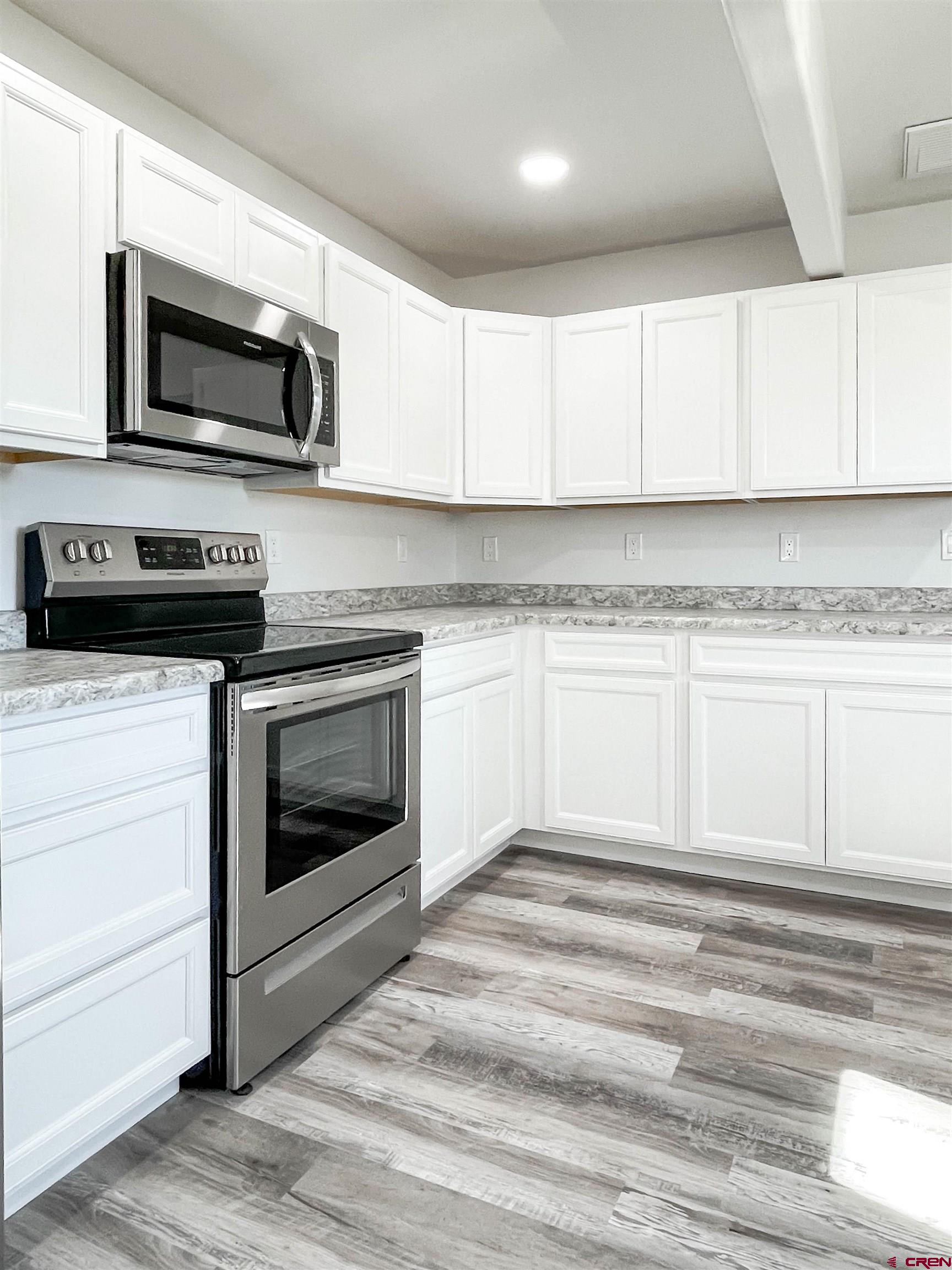 554 A Street Delta, CO 81416 - Photo 15 of 33 a kitchen with granite countertop a stove top oven and cabinets
