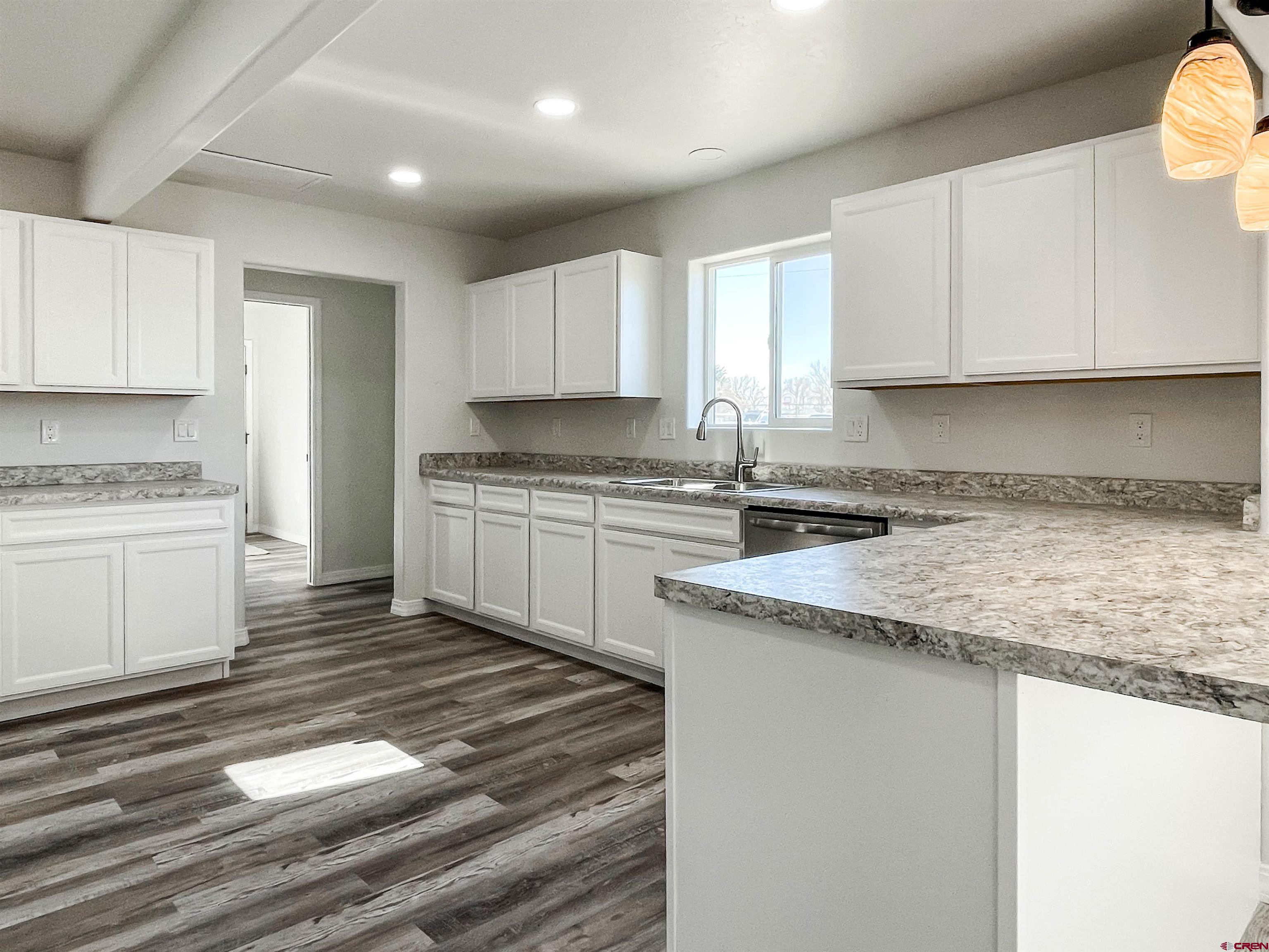 554 A Street Delta, CO 81416 - Photo 17 of 33 a kitchen with granite countertop a sink stainless steel appliances and cabinets