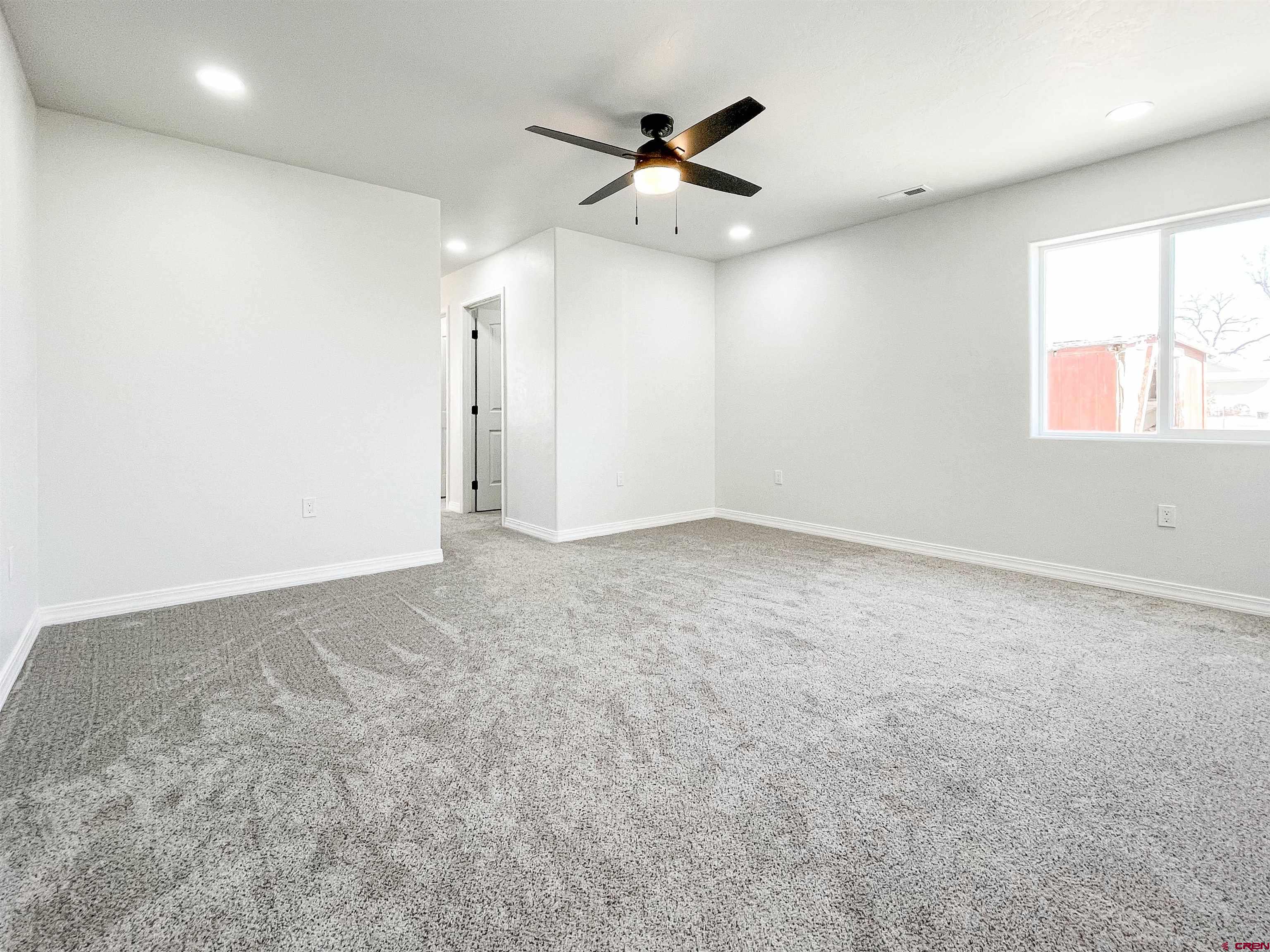 554 A Street Delta, CO 81416 - Photo 18 of 33 an empty room with a ceiling fan and window