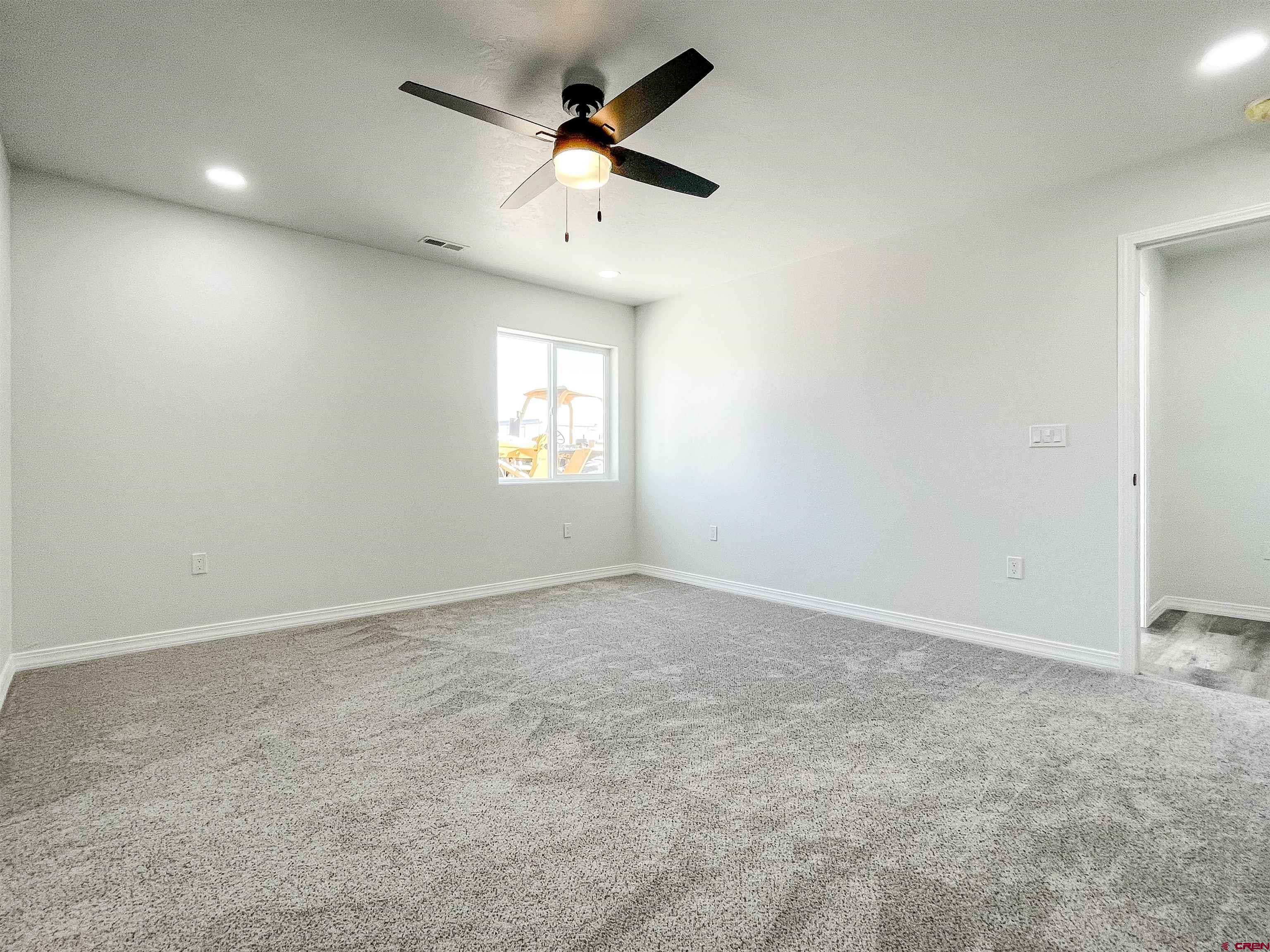 554 A Street Delta, CO 81416 - Photo 19 of 33 an empty room with a window and a ceiling fan