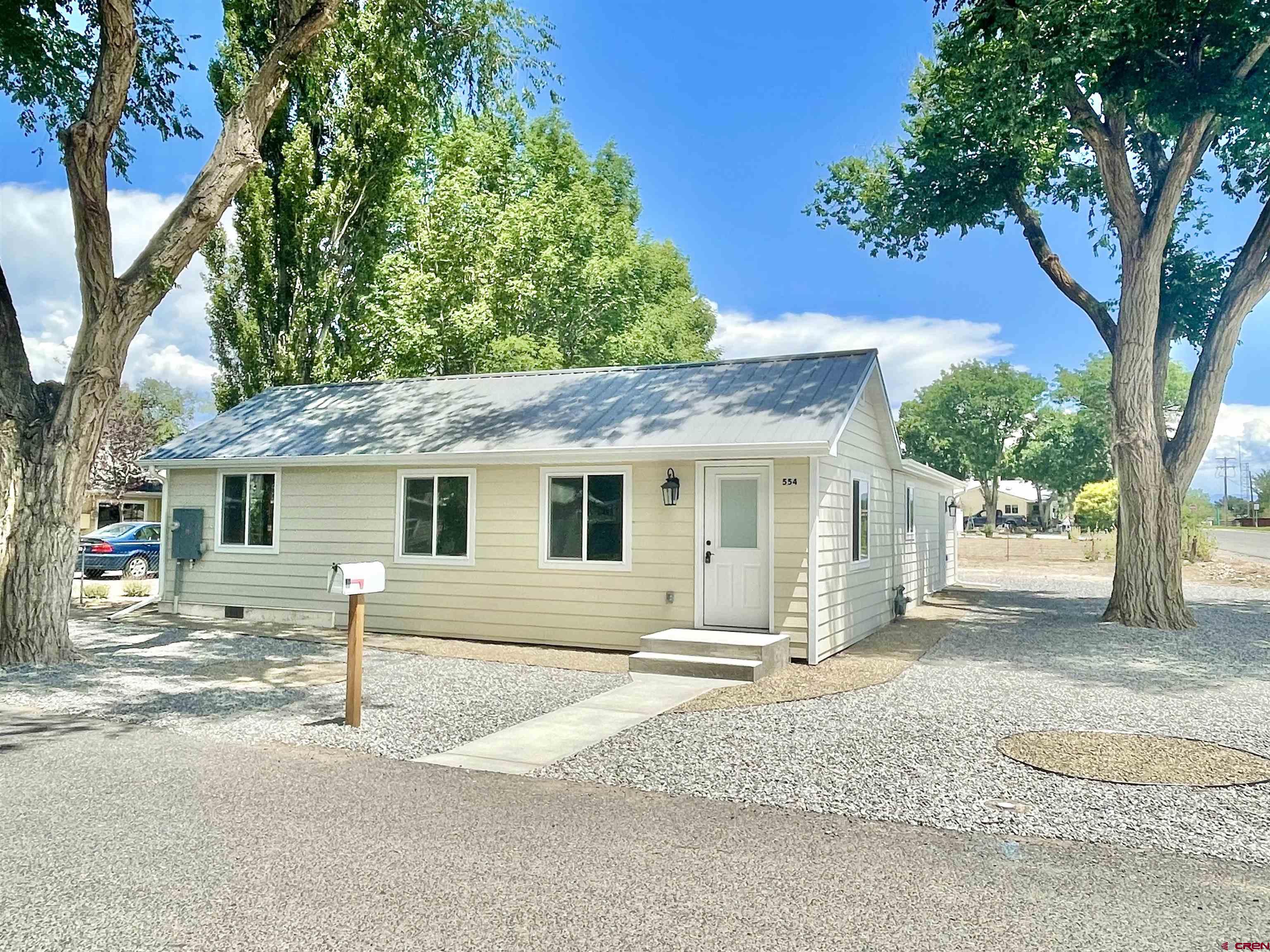 554 A Street Delta, CO 81416 - Photo 2 of 33 front view of a house with a bench and trees