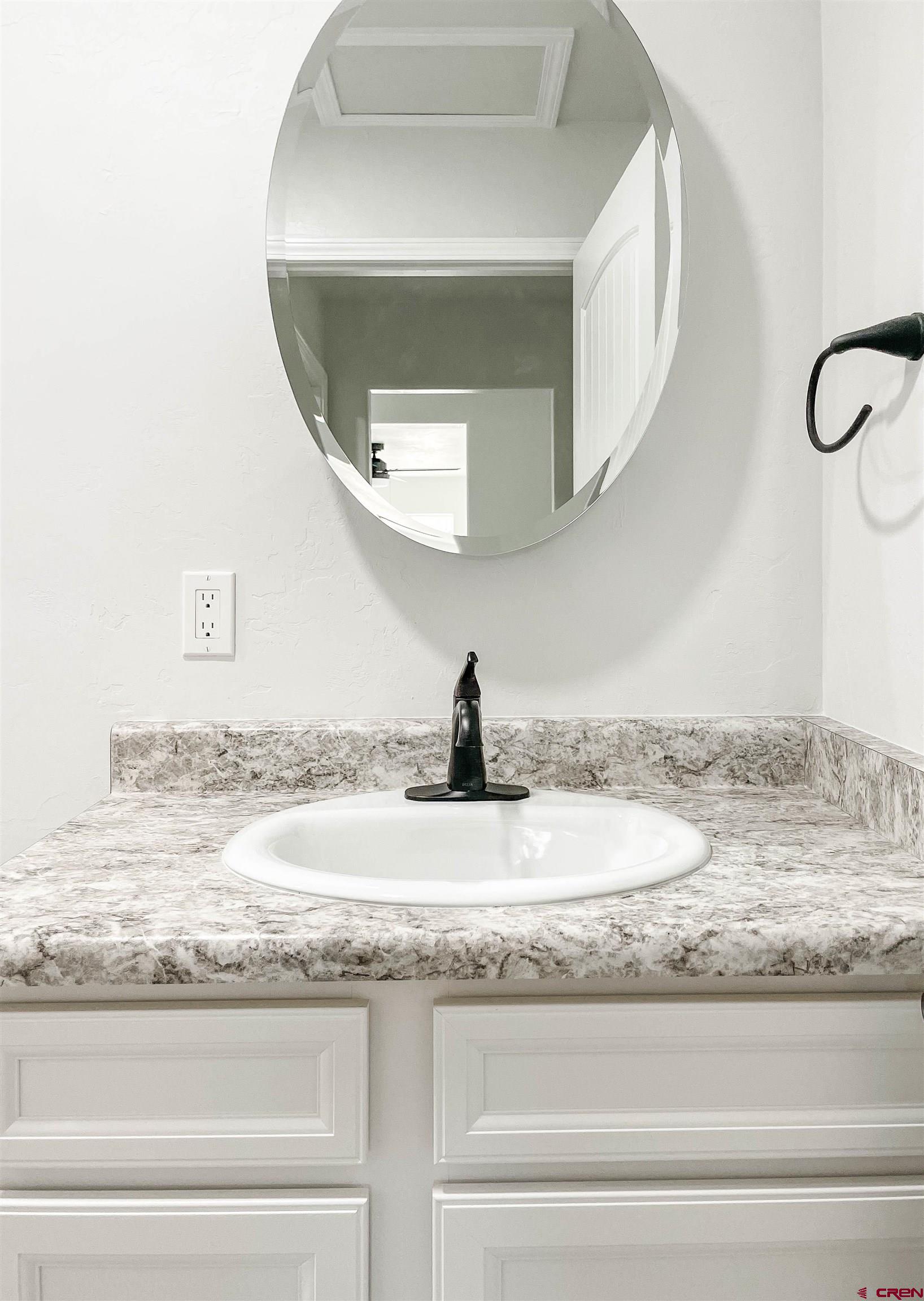 554 A Street Delta, CO 81416 - Photo 31 of 33 a bathroom with a granite countertop sink and mirror