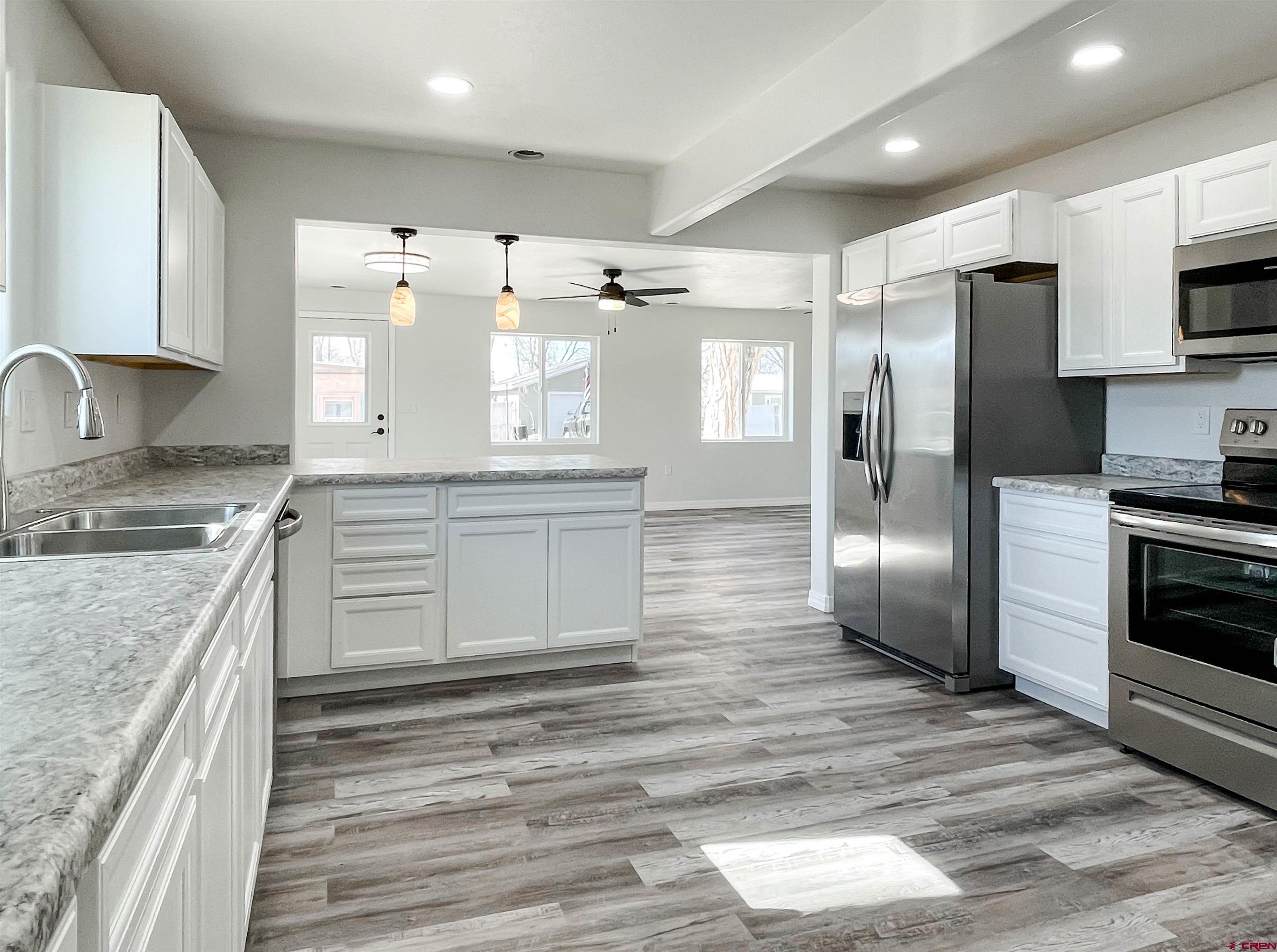 554 A Street Delta, CO 81416 - Photo 9 of 33 a kitchen with stainless steel appliances granite countertop a sink stove and refrigerator