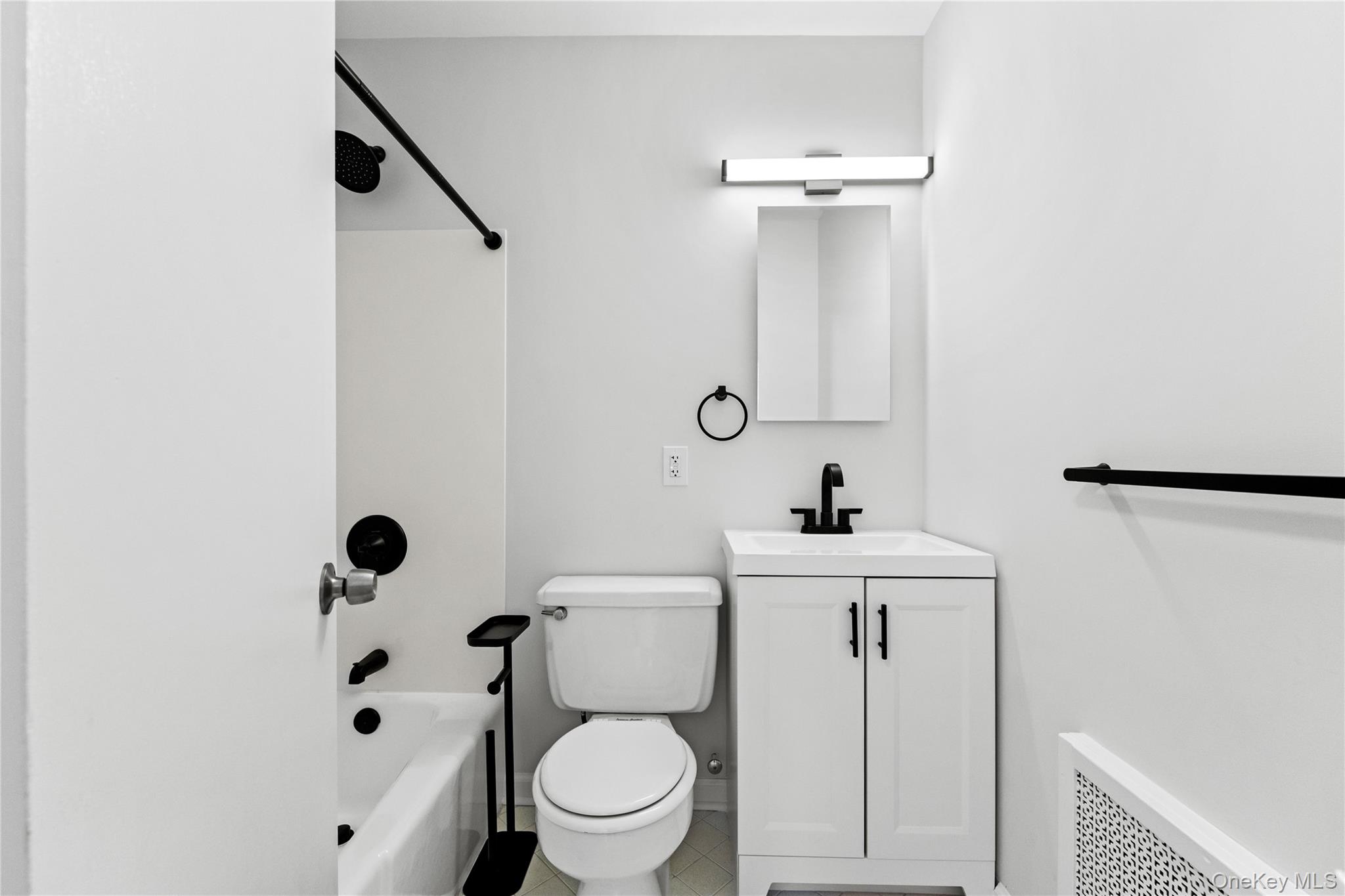 3 Harbor Lane, Unit 3A New Rochelle, NY 10805 - Photo 12 of 16 a bathroom with a sink a toilet and shower