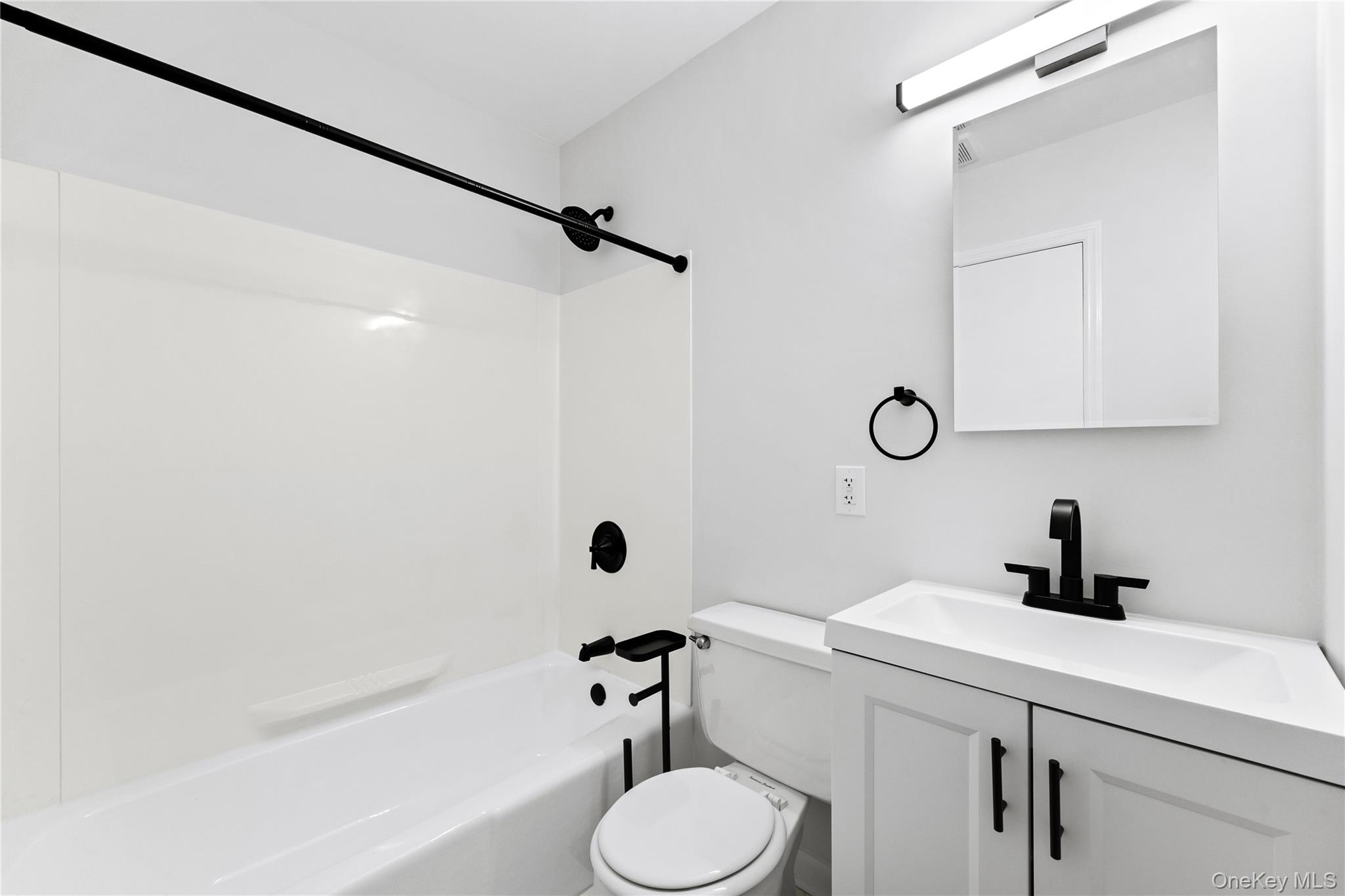 3 Harbor Lane, Unit 3A New Rochelle, NY 10805 - Photo 13 of 16 a bathroom with a sink a toilet a mirror and shower