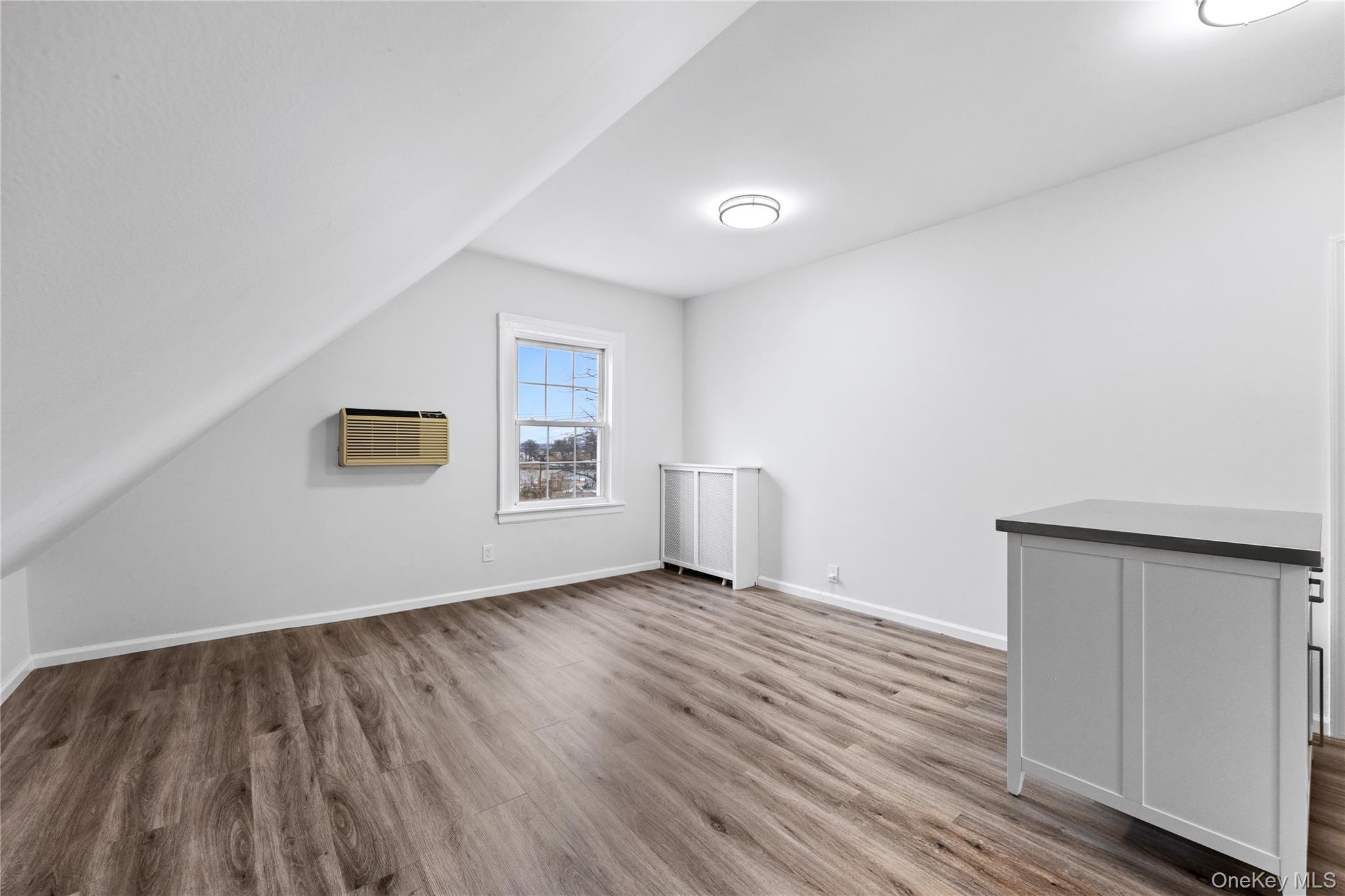 3 Harbor Lane, Unit 3A New Rochelle, NY 10805 - Photo 4 of 16 an empty room with wooden floor and windows